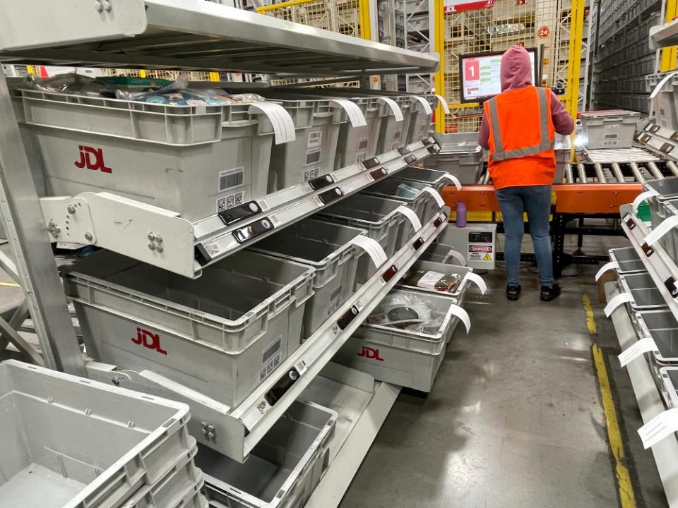 A worker sorts items for packaging and shipping. 