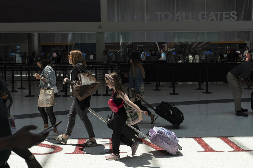 Travelers make their way through the Nashville International Airport Thursday, May 25, 2023, in Nashville, Tenn. (AP Photo/George Walker IV)