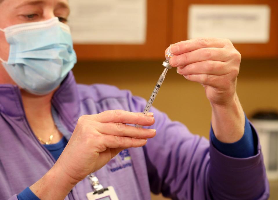 Julie Harvey, a registered nurse at the IHA Pediatrics medical office in Plymouth, Michigan, slowly adds the right dosage of the Pfizer coronavirus vaccine to be given to kids ages 5-11 on Nov. 3, 2021. Federal regulators approved the vaccine for 5- to 11-year-olds Tuesday night.