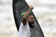 Brazil's Italo Ferreira celebrates winning the gold medal in the men's surfing competition at the 2020 Summer Olympics, Tuesday, July 27, 2021, at Tsurigasaki beach in Ichinomiya, Japan. (AP Photo/Francisco Seco)