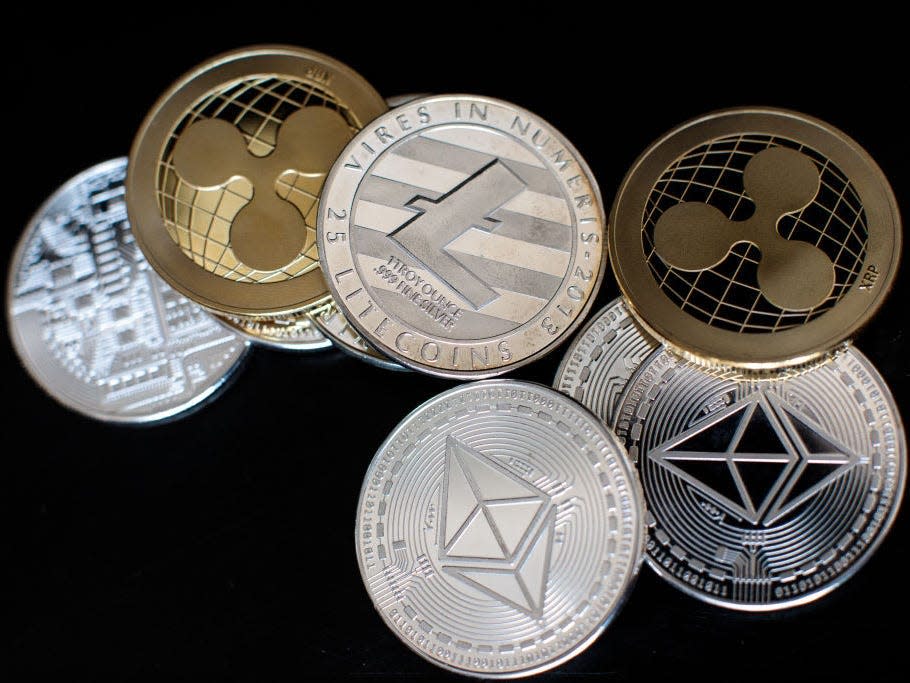 In this photo illustration of the litecoin, ripple and ethereum cryptocurrency 'altcoins' sit arranged for a photograph