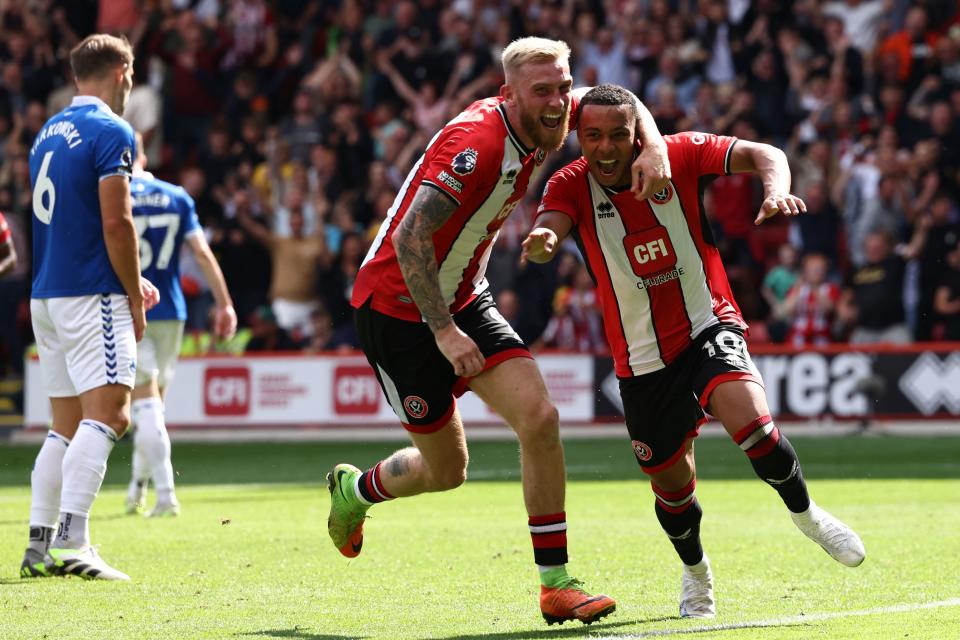 Sheffield United's English striker #10 Cameron Archer (R) celebrates with Sheffield United's English-born Scottish striker #09 Oli McBurnie (C) after scoring their first goal during the English Premier League football match between Sheffield United and Everton at Bramall Lane in Sheffield, northern England on September 2, 2023. (Photo by Darren Staples / AFP) / RESTRICTED TO EDITORIAL USE. No use with unauthorized audio, video, data, fixture lists, club/league logos or 'live' services. Online in-match use limited to 120 images. An additional 40 images may be used in extra time. No video emulation. Social media in-match use limited to 120 images. An additional 40 images may be used in extra time. No use in betting publications, games or single club/league/player publications. /  (Photo by DARREN STAPLES/AFP via Getty Images)