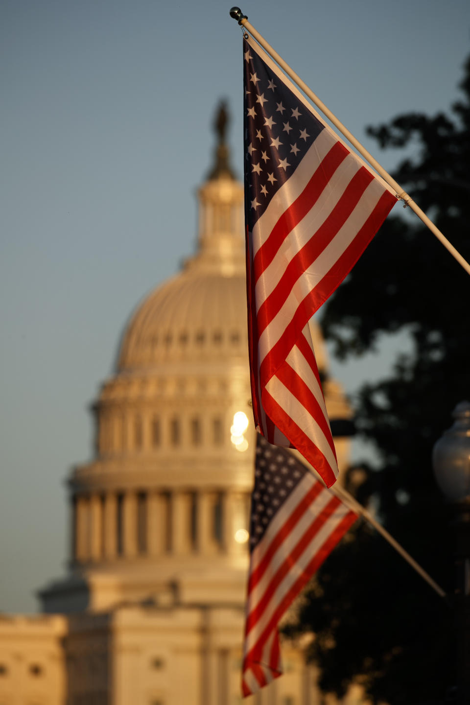 Flags fly at sunset with 51 instead of the usual 50 stars, along Pennsylvania Ave., part of a display in support of statehood for the District of Columbia, Sunday, Sept. 15, 2019, in Washington. (AP Photo/Jacquelyn Martin)