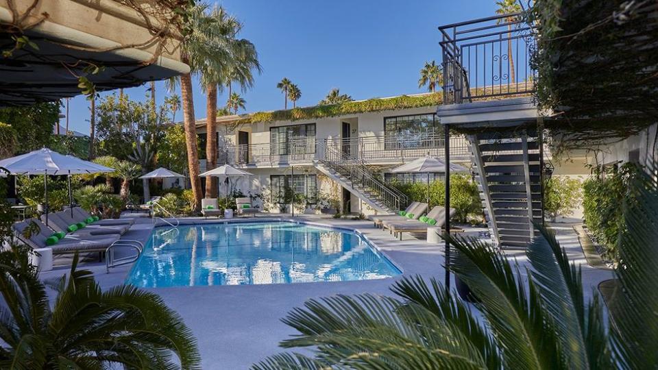 The heated pool and lush grounds at the Descanso Resort, a gay men's clothing optional resort in Palm Springs