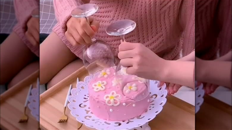 wine glass cake cutting hake with pink cake