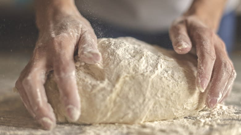 Hands kneading bread dough