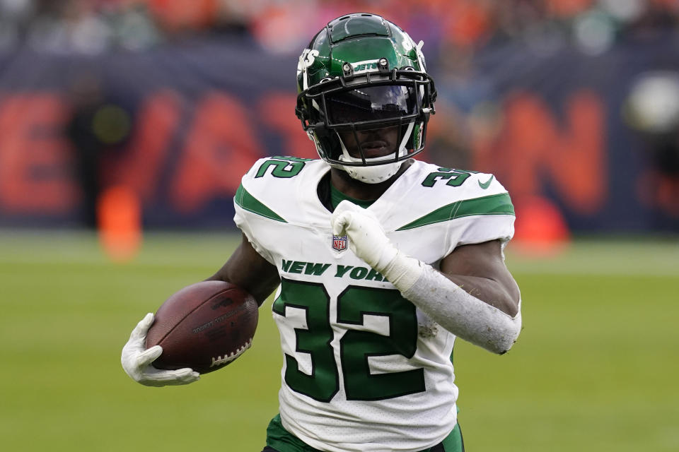 New York Jets running back Michael Carter (32) runs against the Denver Broncos during the second half of an NFL football game, Sunday, Oct. 23, 2022, in Denver. (AP Photo/Matt York)