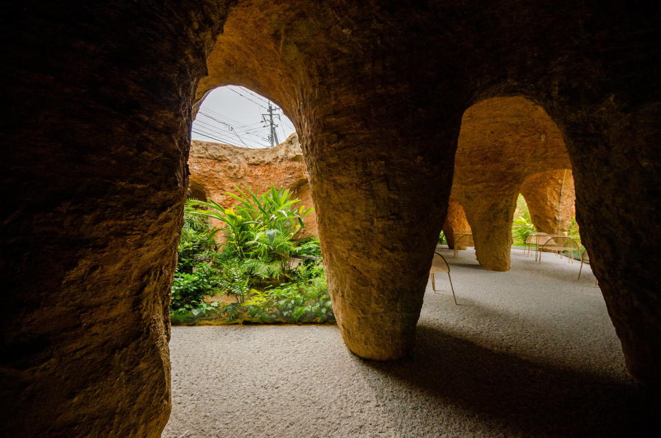 Rugged columns like a cave-like hallway in Junya Ishigami's House and Restaurant Cave.