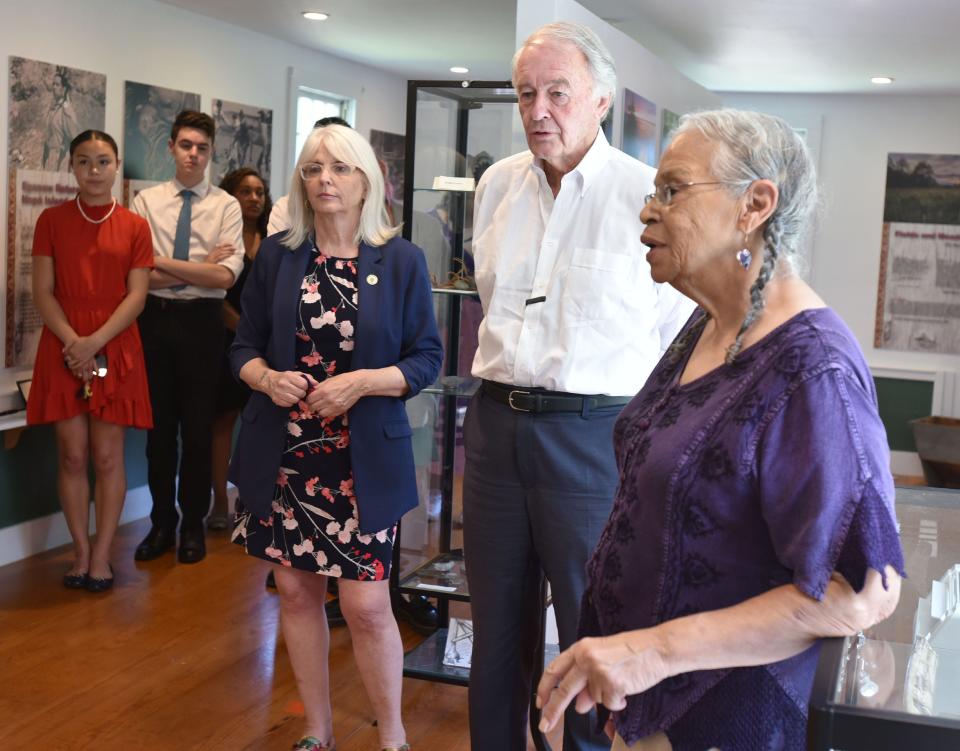 Anita "Mother Bear" Peters describes exhibits to U.S. Sen. Edward Markey, center, and state Sen. Susan Moran during a visit on Tuesday in Mashpee to the Mashpee Wampanoag Museum and other tribal locations .