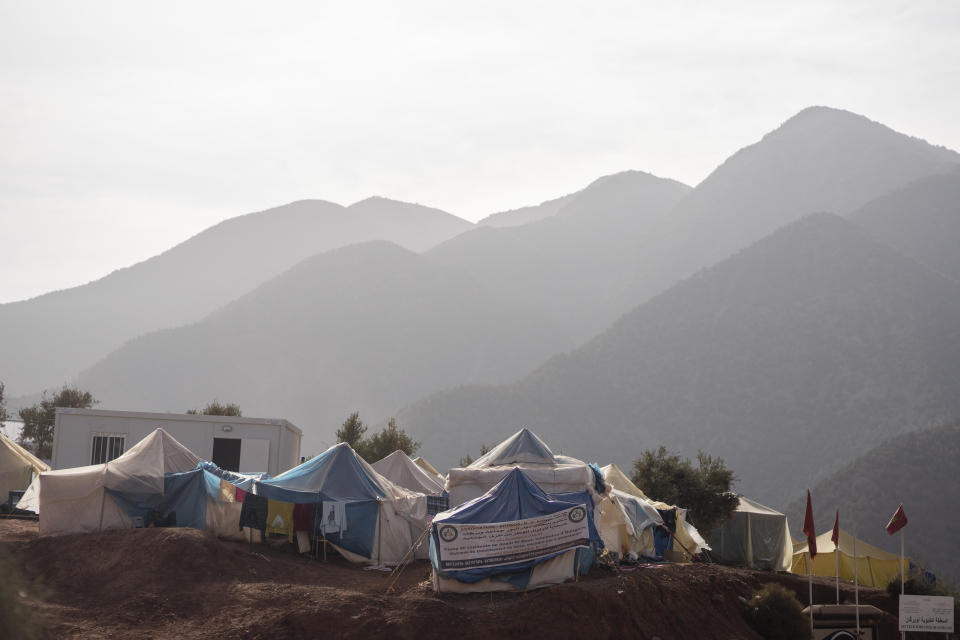 Tents housing people who were displaced by the earthquake are seen against the backdrop of the High Atlas Mountains, in Ouirgane, outside Marrakech, Saturday, Oct. 7, 2023. Morocco has pledged to rebuild from a September earthquake in line with its architectural heritage. Villagers and architects agree that earthquake-safe construction is a top priority. That’s created a push for modern building materials. But the government says it wants to rebuild in line with Morocco’s cultural and architectural heritage. (AP Photo/Mosa'ab Elshamy)