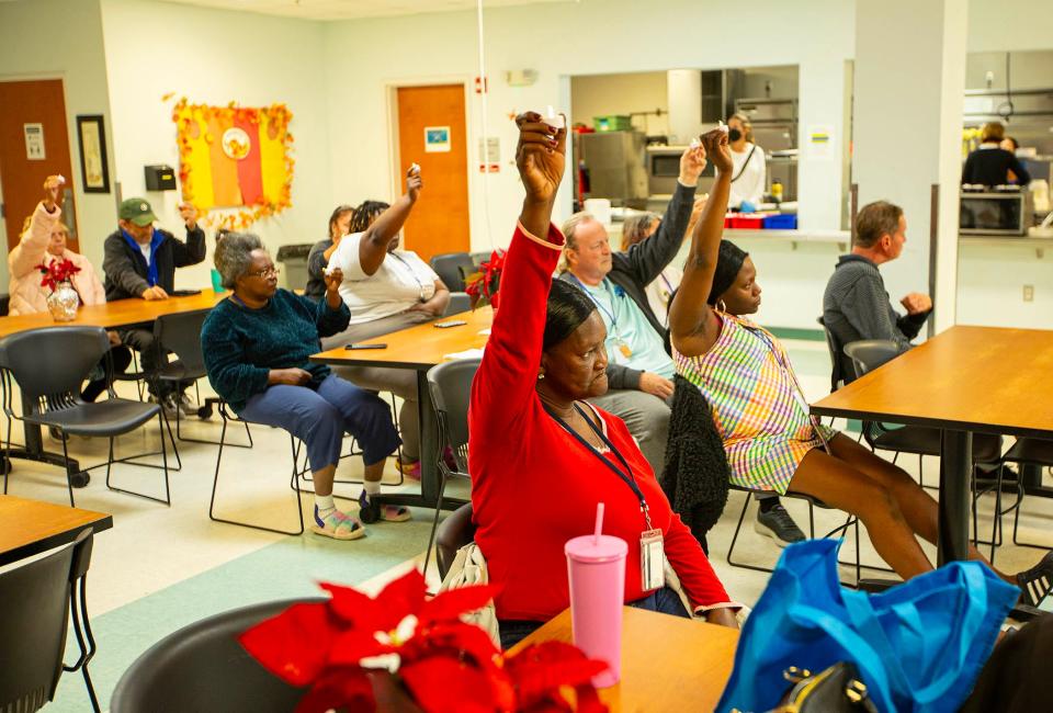 Clients of the Senator Philip D. Lewis Center take part in an event sponsored by the Palm Beach County Homeless Coalition during National Homeless Persons' Remembrance Day on Thursday, Dec. 21, in West Palm Beach.