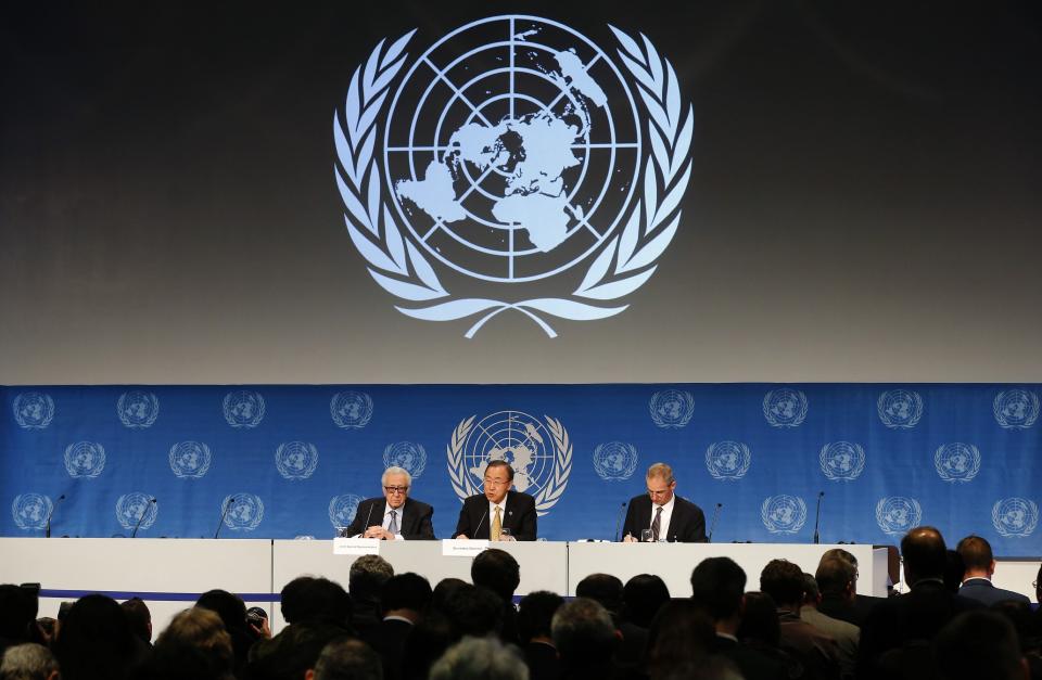 U.N. Secretary-General Ban Ki-moon sits beside U.N.-Arab League envoy for Syria Lakhdar Brahimi as he addresses a news conference after the Geneva-2 peace talks in Montreux
