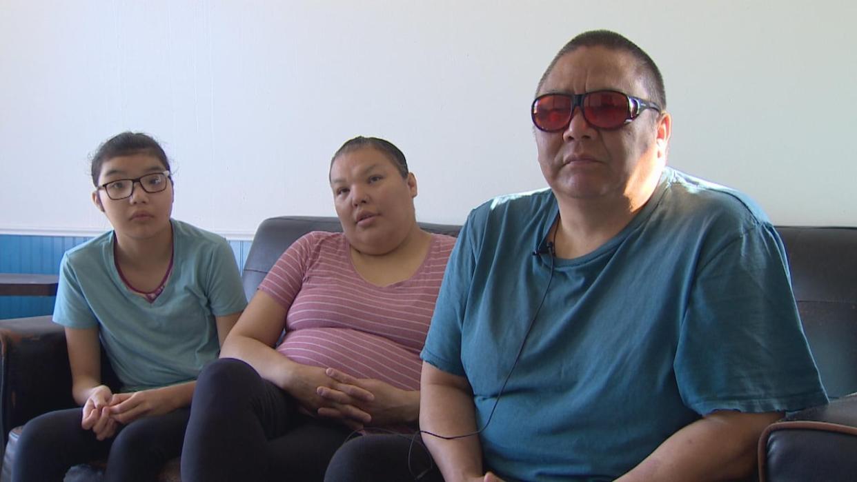 Christopher Dryneck, right, with his wife and daughter. Dryneck says the family's income support was cut after they struggled to provide some needed paperwork. (Robert Holden / CBC - image credit)