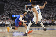 Denver Nuggets guard Jamal Murray, left, works toward the basket as Minnesota Timberwolves center Karl-Anthony Towns (32) defends during the first half of Game 3 of an NBA basketball second-round playoff series, Friday, May 10, 2024, in Minneapolis. (AP Photo/Abbie Parr)
