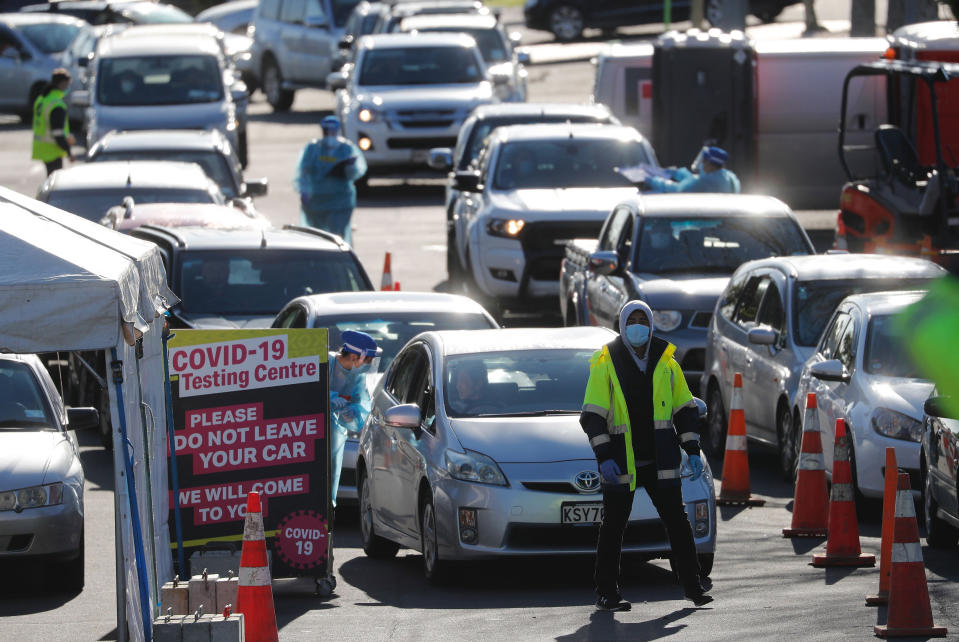 Cars queue at a COVID-19 test centre in Auckland, New Zealand, Thursday, Aug. 13, 2020. Health authorities in New Zealand are scrambling to trace the source of a new outbreak of the coronavirus as the nation's largest city goes back into lockdown. (AP Photo/Dean Purcel)