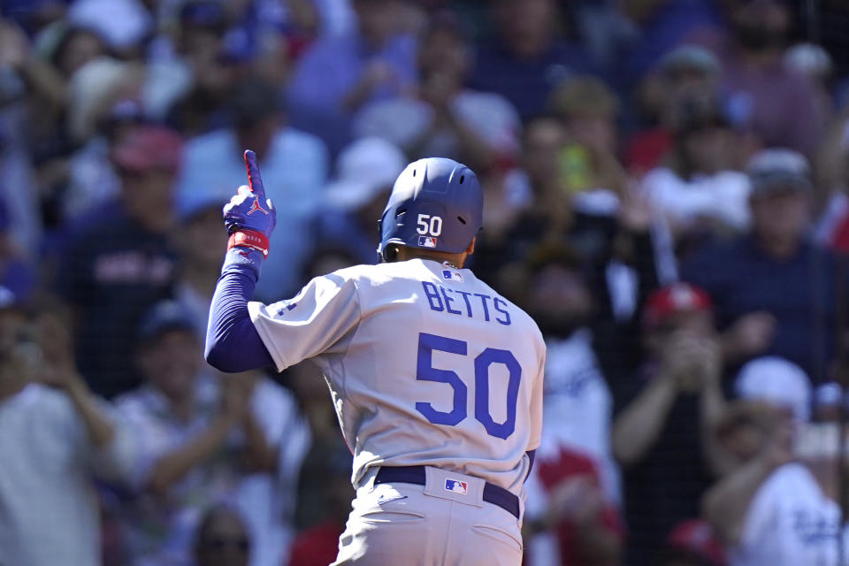 Los Angeles Dodgers' Mookie Betts celebrates after scoring on a two-run home run in the sixth inning of a baseball game against the Boston Red Sox, Sunday, Aug. 27, 2023, in Boston. (AP Photo/Steven Senne)