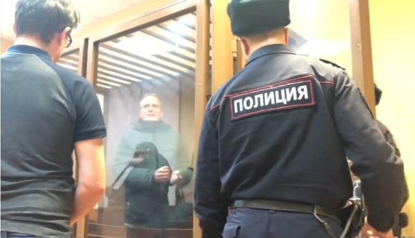 An image from cell phone video obtained by the Reuters news agency shows jailed Danish national Dennis Christensen speaking with a reporter after a court hearing in Oryol, Russia, where he is accused of 