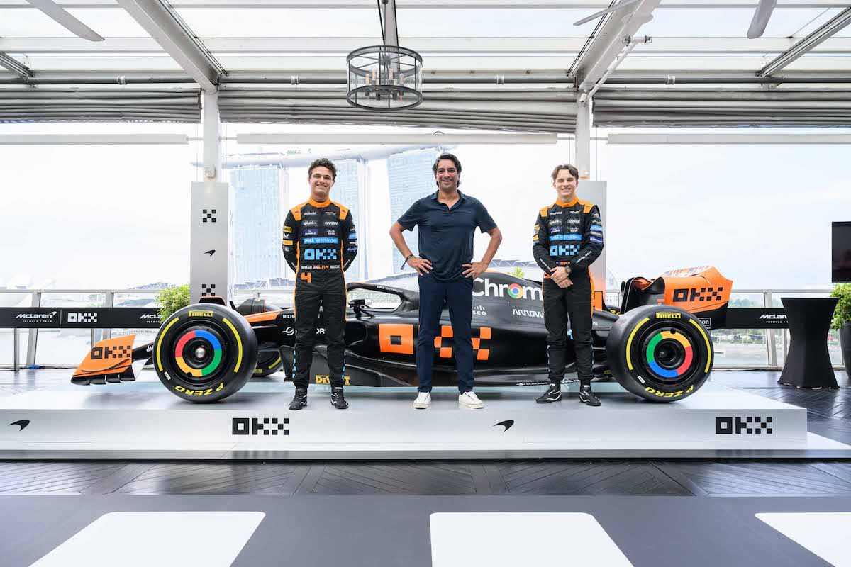 McLaren drivers Lando Norris (left) and Oscar Piastri (right) with OKX chief marketing officer Haider Rafique unveiled the Stealth Mode livery design for the McLaren car to be displayed during the F1 Singapore Grand Prix. (PHOTO: McLaren)