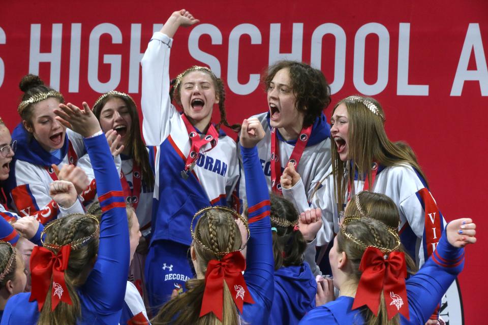 Decorah’s girls wrestling team celebrates its first-place team finish at the state tournament in Coralville on Friday.