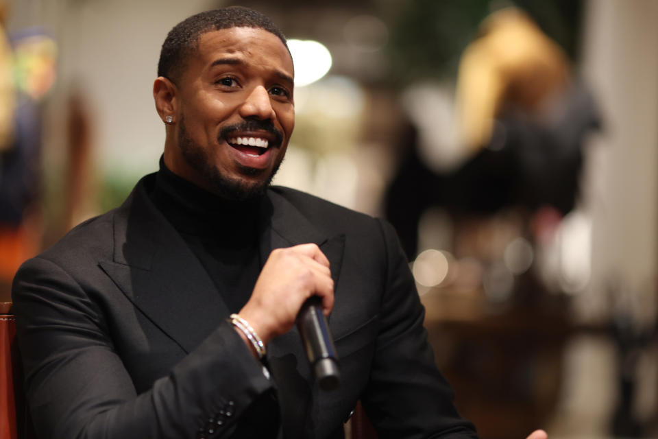 Michael B Jordan speaking into a microphone