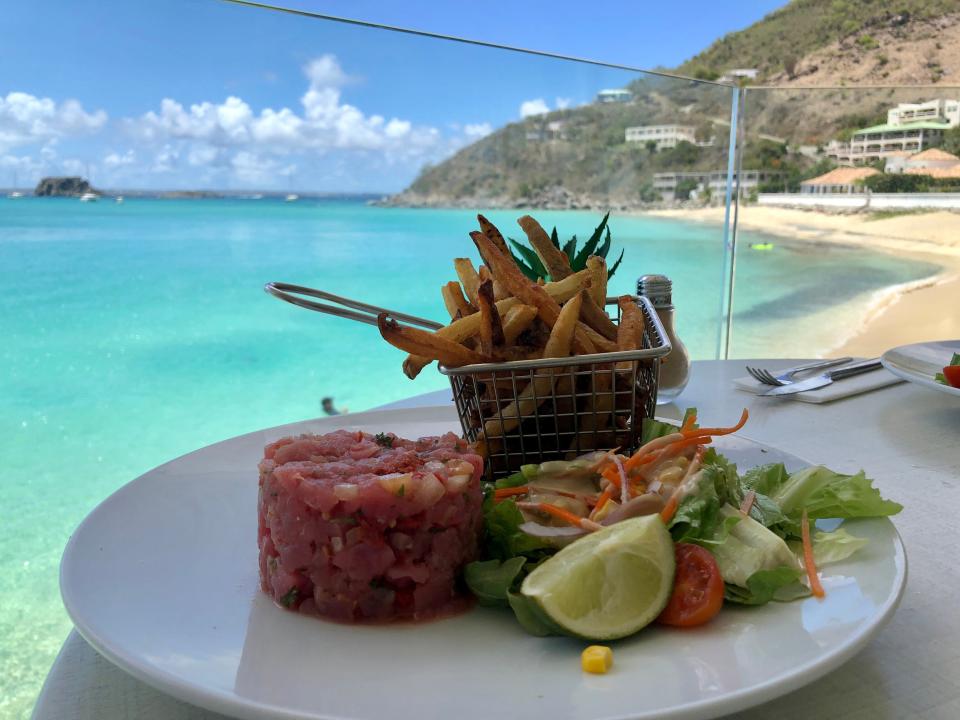 A plate of lunch on a seaside table at Sunset Cafe in St. Martin.