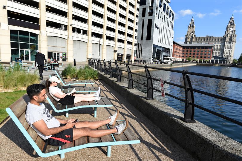 People relaxing in the sunshine at Princes Dock