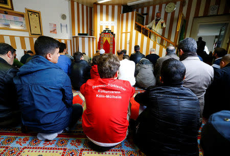 Young Muslims listen to a Turkish imam during Friday prayers at the Turkish Kuba Camii mosque located near a hotel housing refugees in Cologne's district of Kalk, Germany, October 14, 2016. REUTERS/Wolfgang Rattay