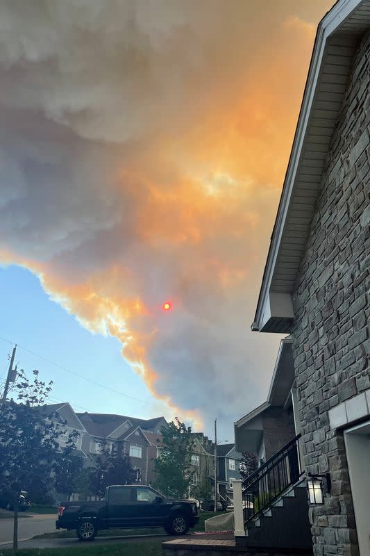 Smoke from the Tantallon wildfire rises over houses in nearby Bedford