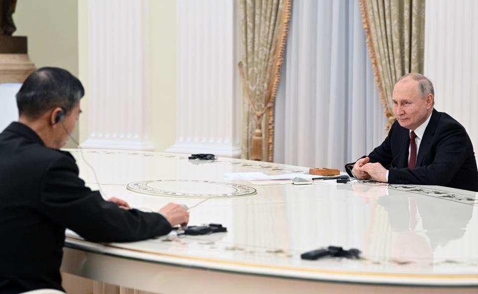 Russian President Vladimir Putin, right, listens to China's Defense Minister Gen. Li Shangfu at the Kremlin in Moscow, Russia, Sunday, April 16, 2023. (Pavel Bednyakov, Sputnik, Kremlin Pool Photo via AP)