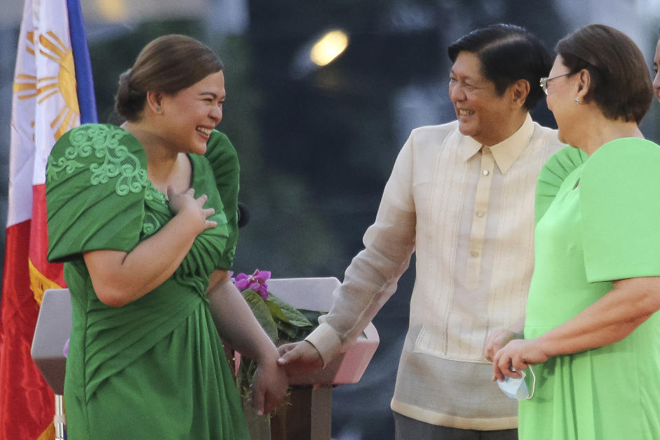 Philippine Vice President-elect Sara Duterte, left, the daughter of outgoing populist president of the Philippines, is greeted by incoming Philippine President Ferdinand "Bongbong" Marcos Jr. after oath-taking rites in her hometown in Davao city, southern Philippines on Sunday, June 19, 2022. Duterte clinched a landslide electoral victory despite her father's human rights record that saw thousands of drug suspects gunned down. (AP Photo/Manman Dejeto)