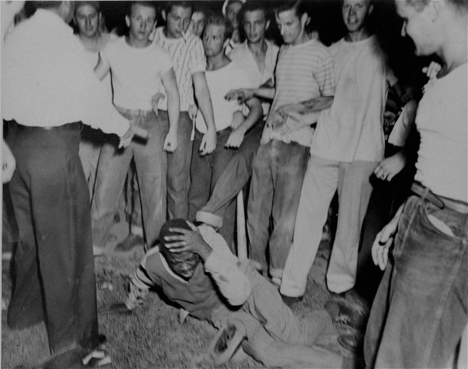 Surrounded by a group of white youths, an unidentified black man grimaces as a policeman tries to halt an attack on him in St. Louis, Missouri, in 1949. <a href="http://www.apimages.com/metadata/Index/Associated-Press-Domestic-News-Missouri-United-/f1eabf7439e5da11af9f0014c2589dfb/1/0" rel="nofollow noopener" target="_blank" data-ylk="slk:AP Photo;elm:context_link;itc:0;sec:content-canvas" class="link ">AP Photo</a>