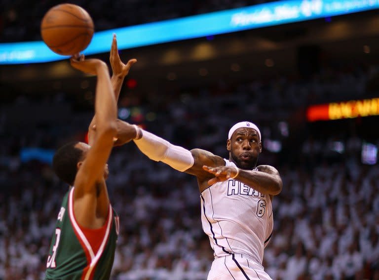 LeBron James passes against the Milwaukee Bucks on April 21, 2013. James and the reigning NBA champion Miami Heat opened their playoff campaign in style with a wire-to-wire 110-87 victory