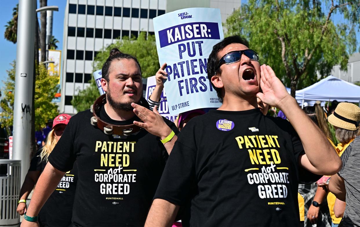 Kaiser Permanente employees and other union backers walk a picket line in Los Angeles on Oct. 5, 2023, during the second day of a strike.