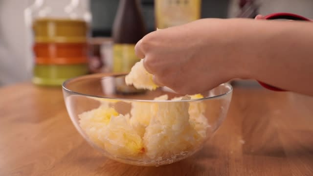 Cutting white fungus into chunks with scissors