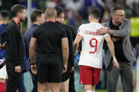 Poland's head coach Czeslaw Michniewicz, right, embraces Robert Lewandowski (9) after the World Cup round of 16 soccer match between France and Poland, at the Al Thumama Stadium in Doha, Qatar, Sunday, Dec. 4, 2022. (AP Photo/Natacha Pisarenko)