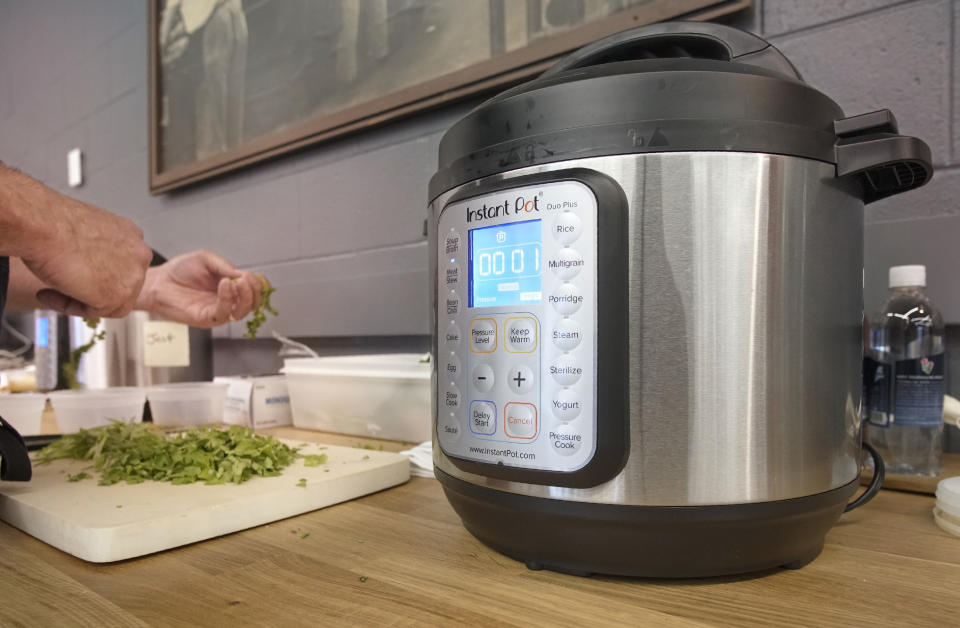 SOUTH PORTLAND, ME - JANUARY 23: With one minute left on the Instant Pot cooking ingredients for Mexican Street Tacos, Nick Verdisco, executive chef at Bolster, Snow & Co. prepares toppings for the tacos, his entry in the Instant Pot Super Bowl Cookoff at the Portland Press Herald cafeteria in South Portland on Tuesday, January 24, 2018. (Staff Photo by Gregory Rec/Portland Portland Press Herald via Getty Images)