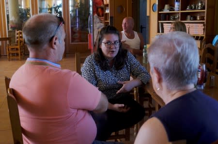 Insurance broker Sophie Goode informs British residents about health care insurance after upcoming Brexit in Benidorm