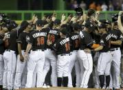 <p>Miami Marlins players wearing a jersey in honor of pitcher Jose Fernandez (16) gather around the pitching mound before a baseball game against the New York Mets, Monday, Sept. 26, 2016, in Miami. Fernandez died in a boating accident Sunday. (AP Photo/Lynne Sladky) </p>