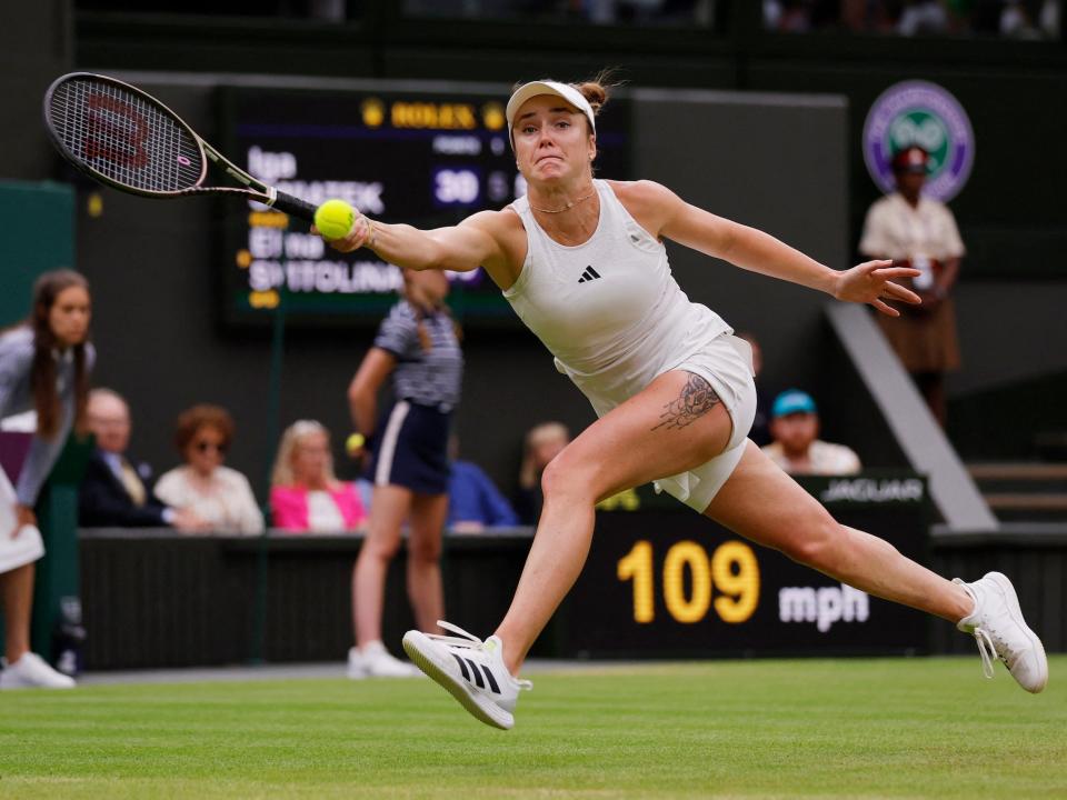 Elina Svitolina stretches for a forehand shot during her semifinal match at Wimbledon 2023.