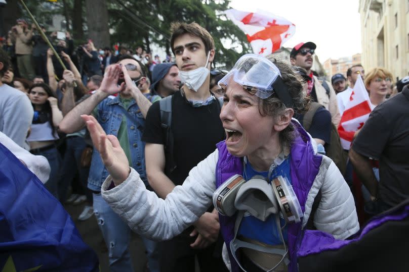 A demonstrator argues with police officers during an opposition protest against the foreign influence bill at the Parliamentary building in Tbilisi, Georgia