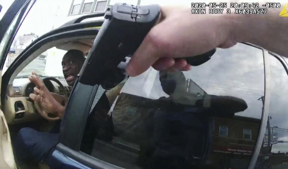 FILE - George Floyd responds to police after they approached his car outside Cup Foods in Minneapolis in this May 25, 2020, file pool photo from police body camera video. A candlelight vigil to honor Floyd's memory at the intersection where he died was among the remembrances scheduled for Wednesday's second anniversary of the Black man's killing at the hands of Minneapolis police officers. (Court TV via AP, Pool, File)