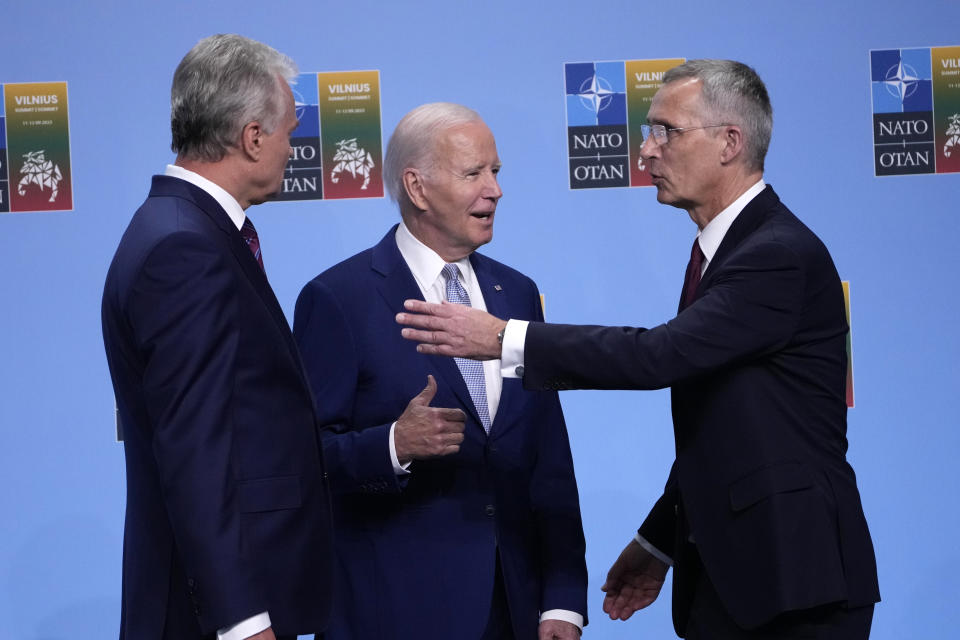 President Joe Biden, center, talks with NATO Secretary General Jens Stoltenberg, right, and Lithuania's President Gitanas Nauseda, left, as he arrives to participate in a family photo at the NATO summit in Vilnius, Lithuania, Tuesday, July 11, 2023. (AP Photo/Susan Walsh, Pool)