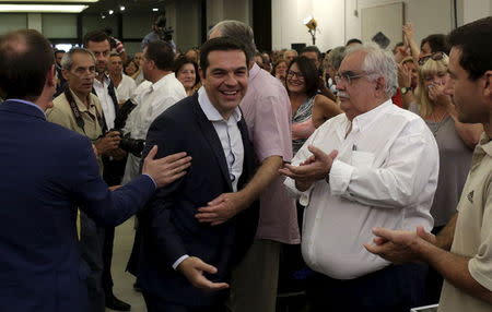 Greek former Prime Minister Alexis Tsipras (C) is welcomed by members of his Syriza party during a meeting in Athens, August 29, 2015. REUTERS/Stoyan Nenov