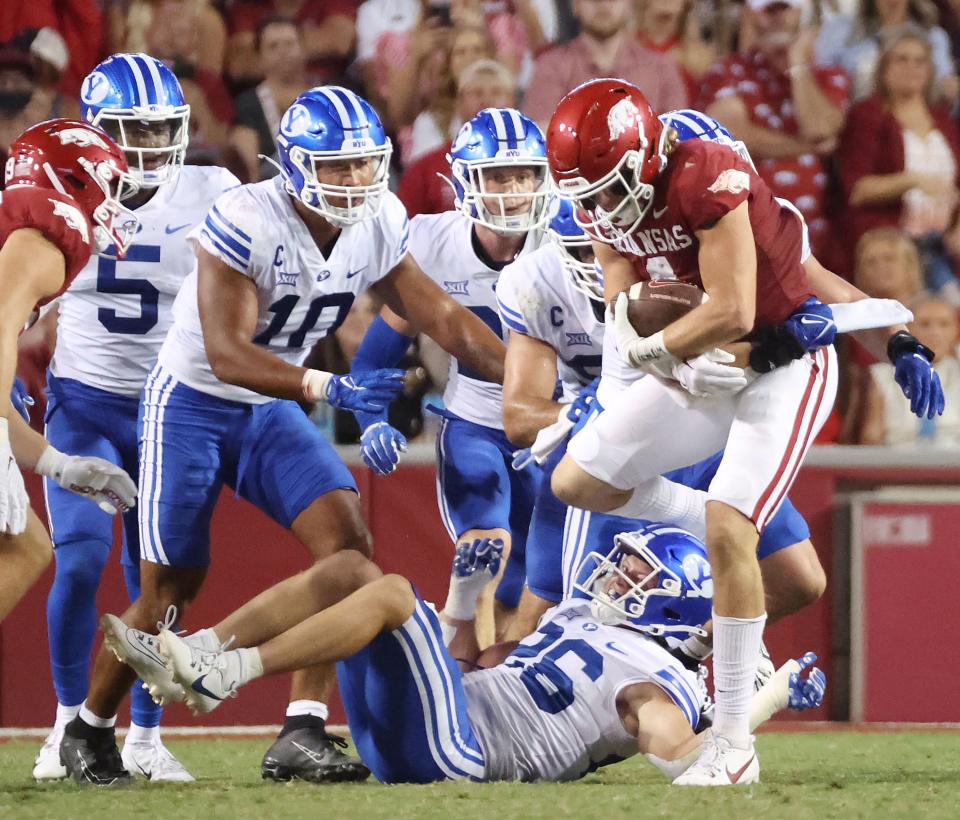 The Brigham Young Cougars defense tackles Arkansas Razorbacks wide receiver Isaac TeSlaa (4) at Razorback Stadium in Fayetteville on Saturday, Sept. 16, 2023. | Jeffrey D. Allred, Deseret News