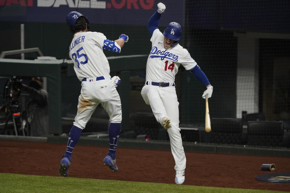 Los Angeles Dodgers' Cody Bellinger celebrates his home run with Enrique Hernandez against the Atlanta Braves during the seventh inning in Game 7 of a baseball National League Championship Series Sunday, Oct. 18, 2020, in Arlington, Texas.(AP Photo/Tony Gutierrez)