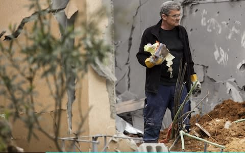 Robert Wolf stands inside his house that was hit by a rocket in the village of Mishmeret, north of Tel Aviv - Credit: Amir Levy/Getty Images