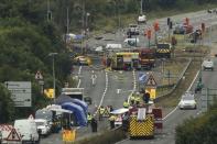 Emergency services and crash investigation officers work at the site where a Hawker Hunter fighter jet crashed onto the A27 road at Shoreham near Brighton, Britain August 23, 2015. REUTERS/Luke MacGregor