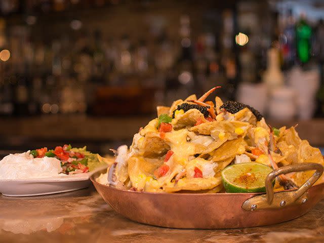 <p>The nachos at <a href="https://www.tripadvisor.com/Restaurant_Review-g56003-d442217-Reviews-Brennan_s_of_Houston-Houston_Texas.html" rel="nofollow noopener" target="_blank" data-ylk="slk:Brennan’s;elm:context_link;itc:0;sec:content-canvas" class="link ">Brennan’s</a> are not your average sports bar nachos. These bad boys are loaded up with a pound Louisiana crab meat, roasted corn, Saint Andre queso, avocado, pico de gallo and lime crema, and Petrossian caviar. </p>