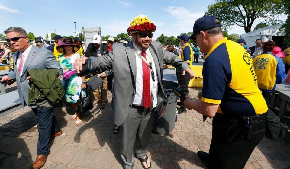 John Aigner, Boise, Idaho, wore a Kentucky Derby hat he made himself, when he was ‘wanded’ by John Severa at the security checkpoint near the Derby Museum at Churchill Downs in Louisville Saturday, May 07, 2016.