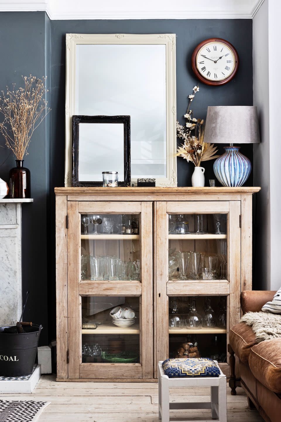 wooden cabinet containing glassware in living room